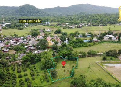 Aerial view of a village and surrounding green fields