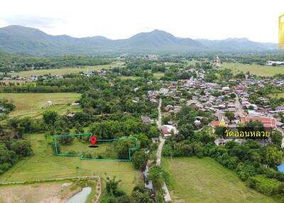 Aerial view of the property and surrounding area with a marked plot