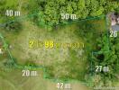 Aerial view of a land plot with marked boundaries and measurements.