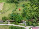 Aerial view of a plot of land marked within a larger green landscape with trees and fields