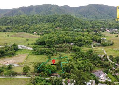 Aerial view of property and surrounding green landscape with mountains