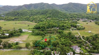 Aerial view of property and surrounding green landscape with mountains