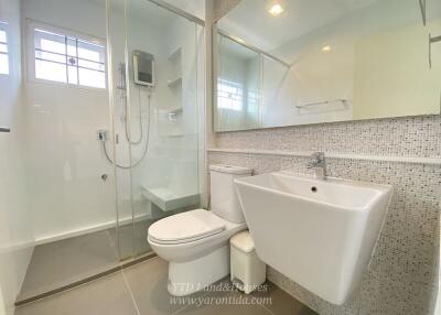 Modern bathroom with shower, toilet, and sink