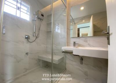 Modern bathroom with glass shower and marble tile