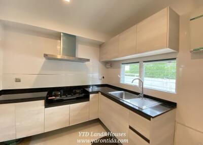 Modern kitchen with sleek cabinets and black countertops