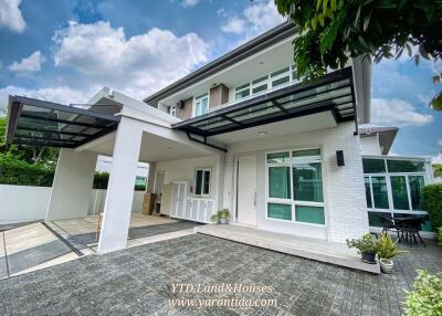 Exterior view of a modern house with a driveway and carport