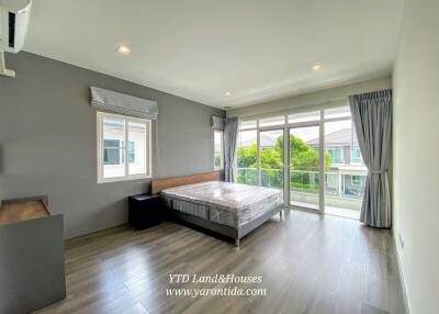 Spacious bedroom with a balcony view