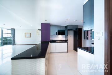 Modern kitchen with black countertops and white cabinets