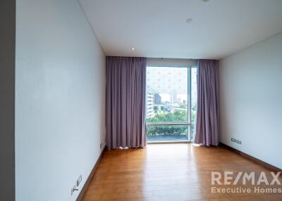 Living room with large window and purple curtains