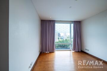 Living room with large window and purple curtains