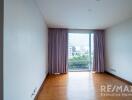 Living room with large window and purple curtains