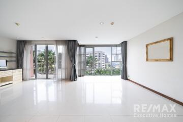 Spacious living room with large windows and balcony view