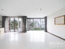 Spacious living room with large windows and balcony view