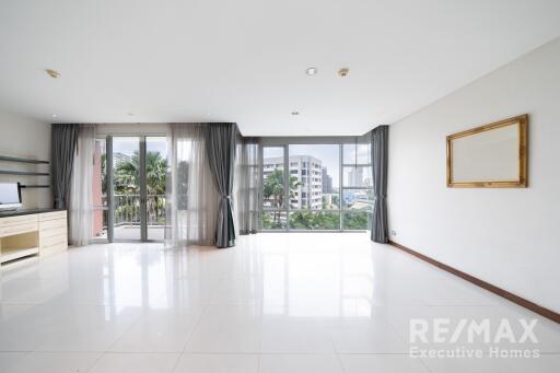 Spacious living room with large windows and balcony view