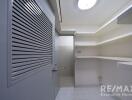 Photo of a utility room with shelves and grey door