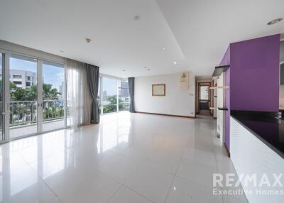 Spacious living room with large windows and balcony