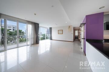 Spacious living room with large windows and balcony