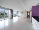 Spacious living room with large windows and balcony