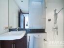 Modern bathroom with shower and vanity for property listing