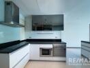 Modern kitchen with appliances and sleek cabinetry