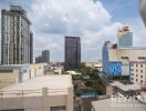 View of the cityscape with multiple buildings under a cloudy sky