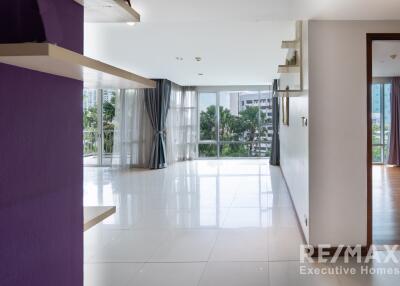 Spacious living room with large windows and city view