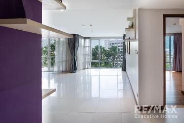 Spacious living room with large windows and city view