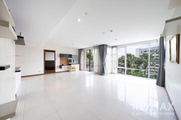 Spacious living room with large windows and plenty of natural light