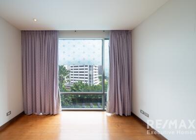 Bedroom with large window and drapes