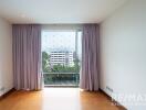 Bedroom with large window and drapes