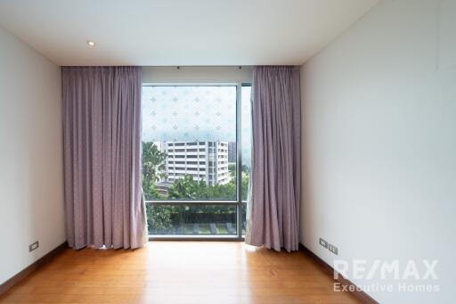 Bedroom with large window and drapes