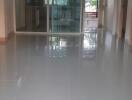 Hallway with polished floors leading to a balcony