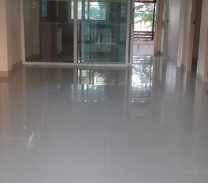 Hallway with polished floors leading to a balcony