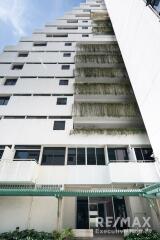 Exterior view of a multistory building with balconies and plants