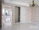 Main living space with chandelier and marble wall