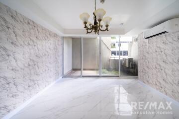 Spacious living room with chandelier and large glass doors