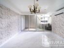 Spacious living room with chandelier and large glass doors