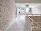 Second-floor hallway with marble patterned walls and natural light