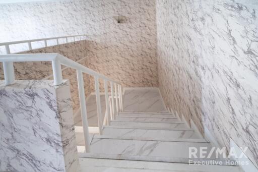 Interior staircase with marble textured walls and steps