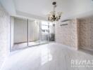 Spacious main living area with sliding glass doors and chandelier