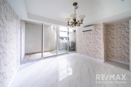 Spacious main living area with sliding glass doors and chandelier