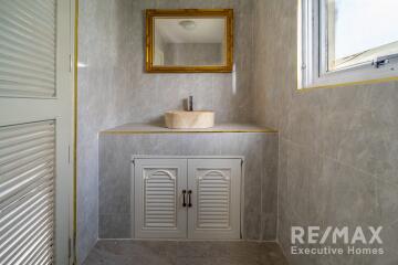 Bathroom with a sink, mirror, and window