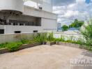 Open balcony area with plants and a city view