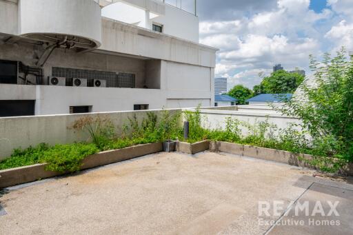 Open balcony area with plants and a city view