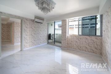 Spacious living room with marble flooring and large windows