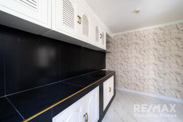 Modern kitchen with black countertops and white cabinets