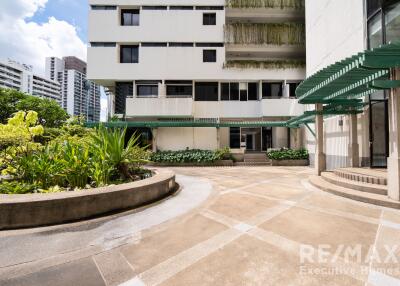 Exterior view of a building with landscaping and patio area