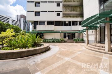 Exterior view of a building with landscaping and patio area