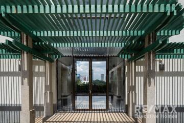 Modern building entrance with green pergola