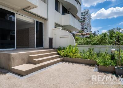 Outdoor patio area with stairs leading to a sliding glass door entry.